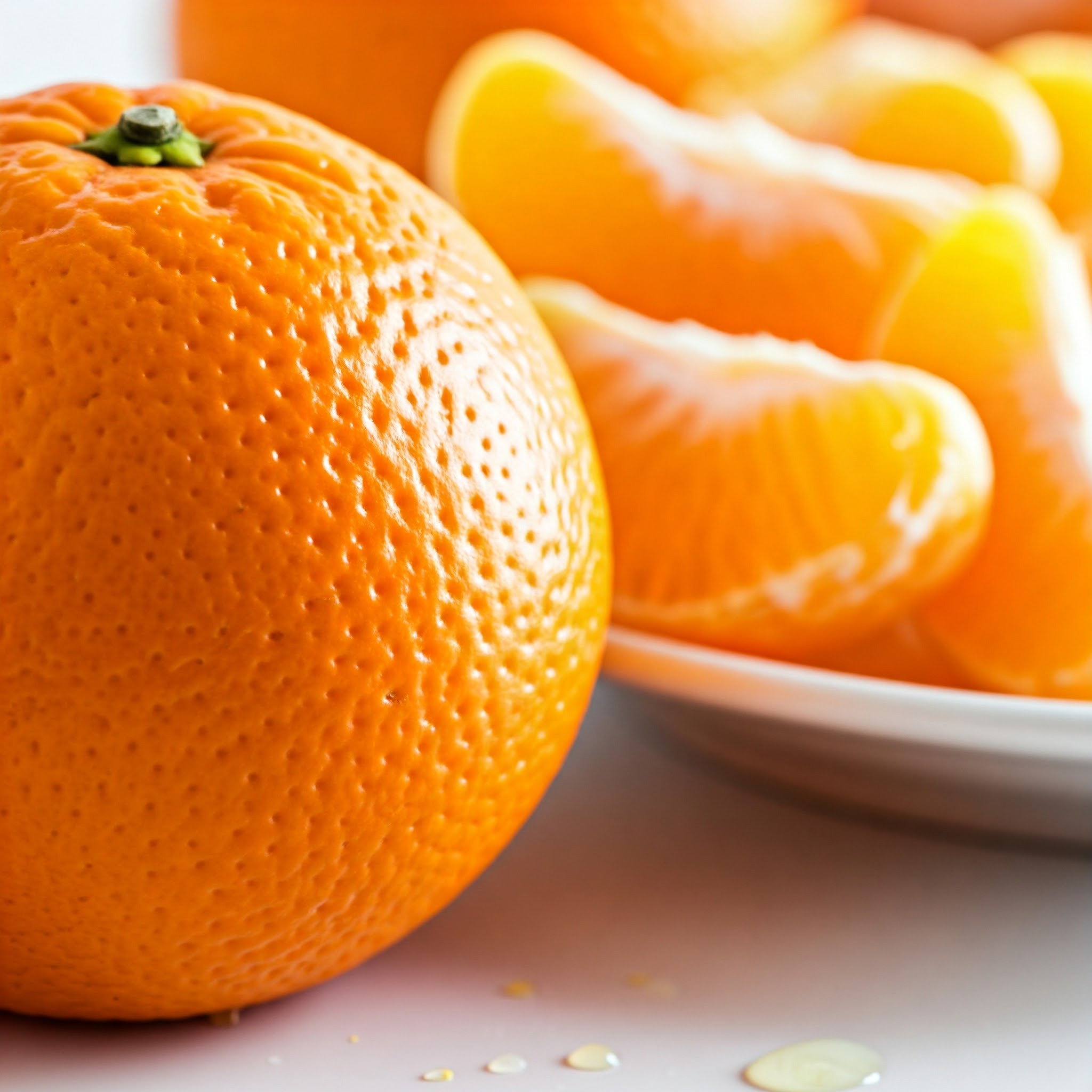 A fresh, juicy orange cut in halves, showcasing vibrant pulp and zest. | Plan your weekly diet with Planmeal